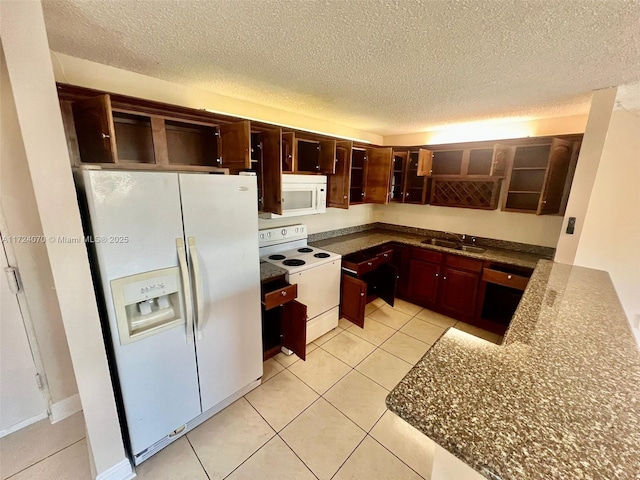 kitchen featuring light tile patterned floors, white appliances, a textured ceiling, and sink