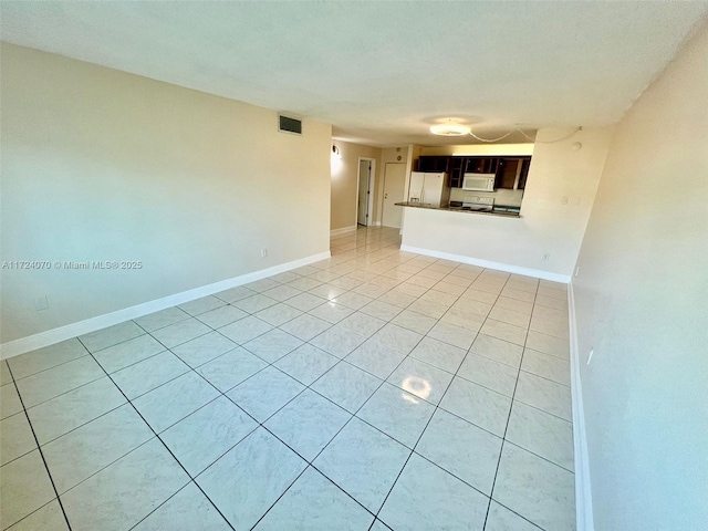 unfurnished living room with light tile patterned floors