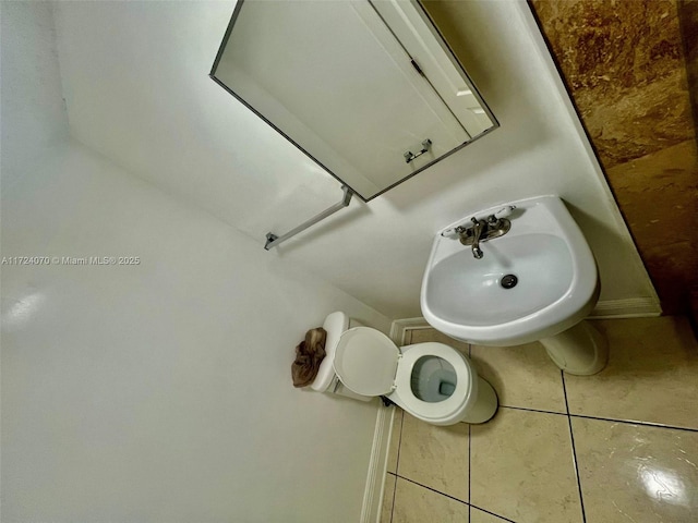 bathroom with tile patterned floors, toilet, and sink