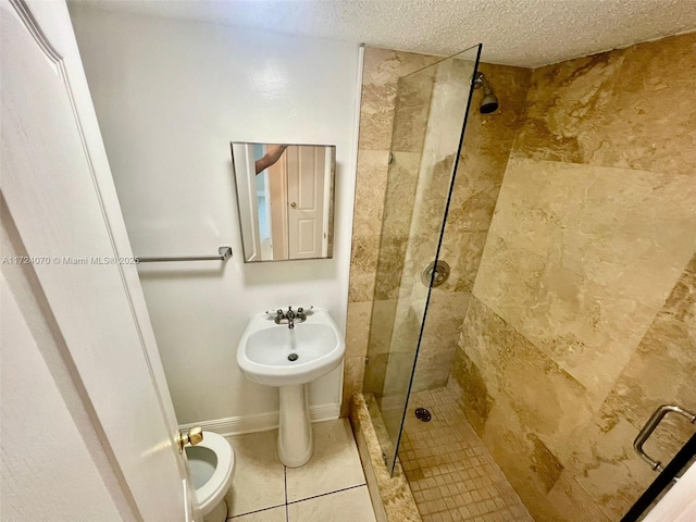 bathroom with an enclosed shower and a textured ceiling