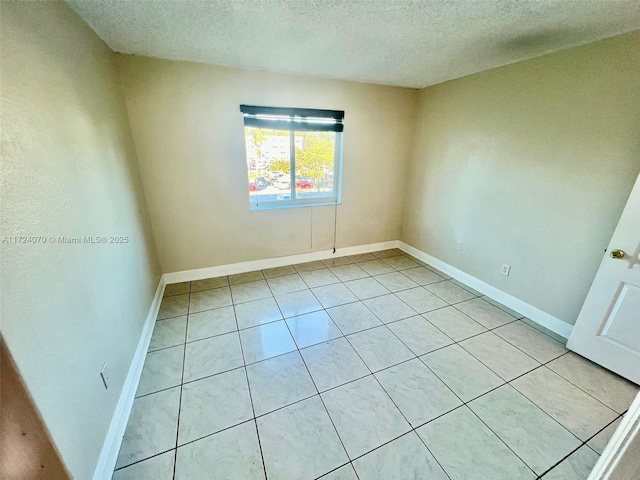 unfurnished room featuring a textured ceiling