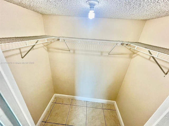 spacious closet with tile patterned floors