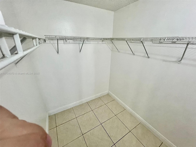 spacious closet featuring light tile patterned floors