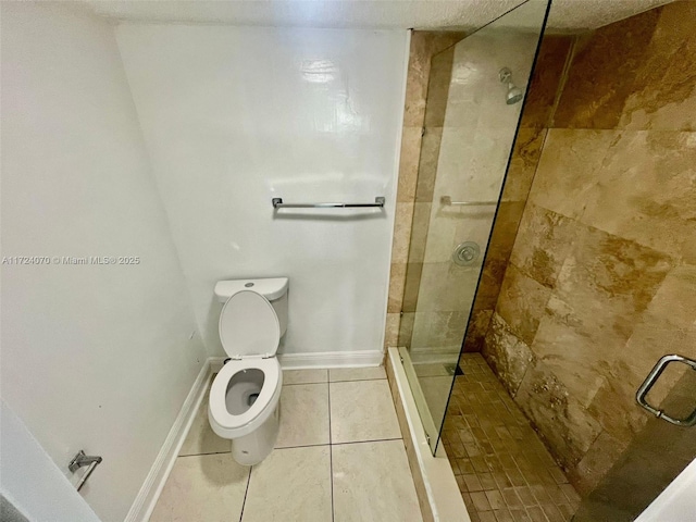 bathroom with tile patterned flooring, a tile shower, and toilet