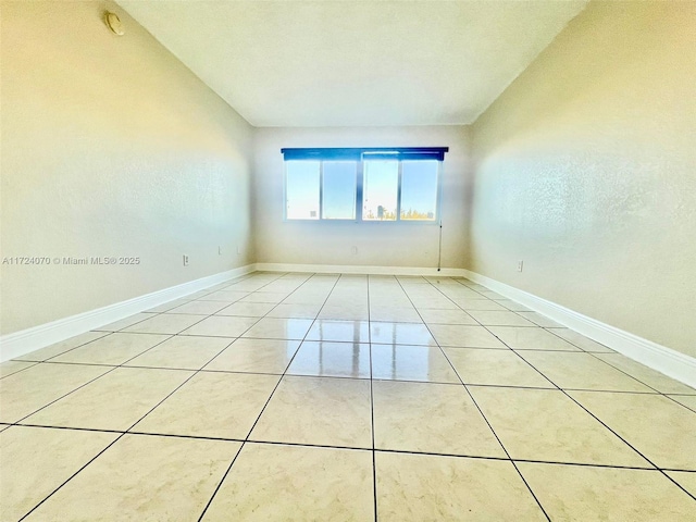 empty room with light tile patterned flooring