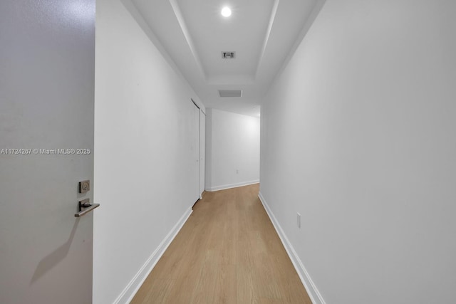 corridor with light hardwood / wood-style floors