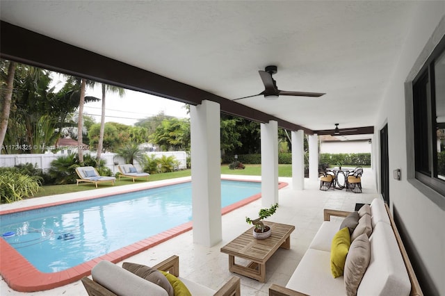 view of swimming pool with ceiling fan, a patio, and outdoor lounge area