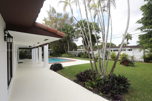 view of swimming pool with a yard and a patio