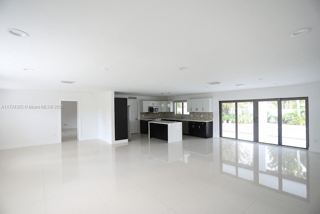 unfurnished living room with tile patterned flooring