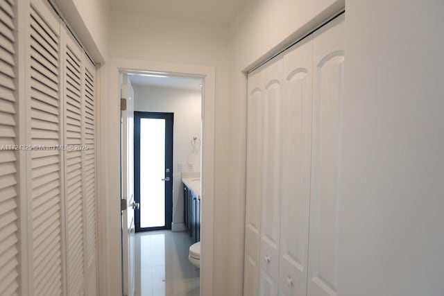 hallway featuring a healthy amount of sunlight and tile patterned floors