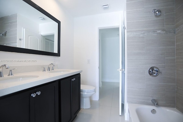 full bathroom with toilet, vanity, tile patterned flooring, and tiled shower / bath combo