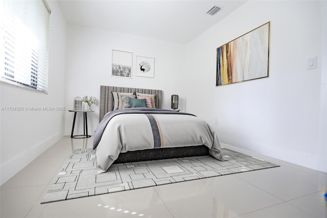 bedroom with light tile patterned floors