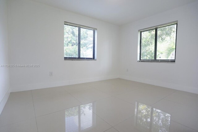 spare room with tile patterned floors