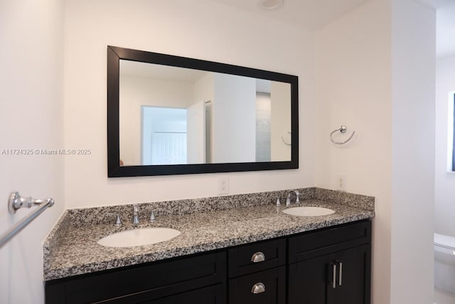 bathroom featuring toilet and vanity