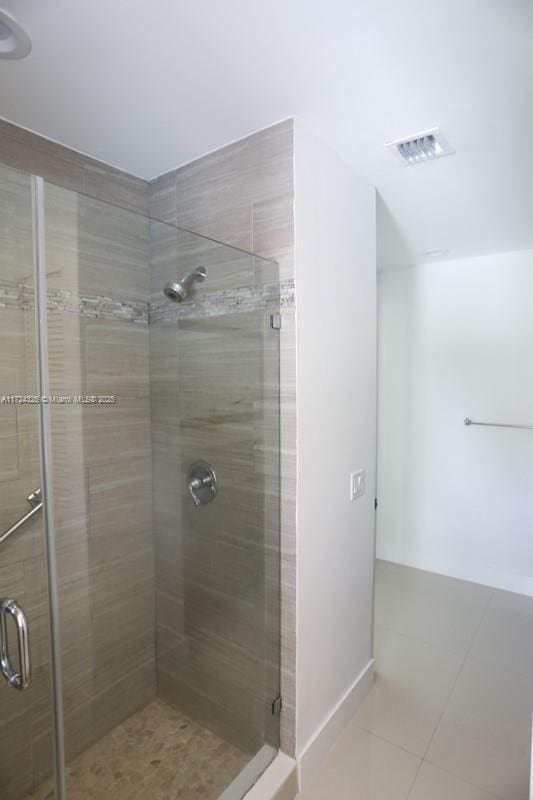 bathroom with tile patterned flooring and an enclosed shower