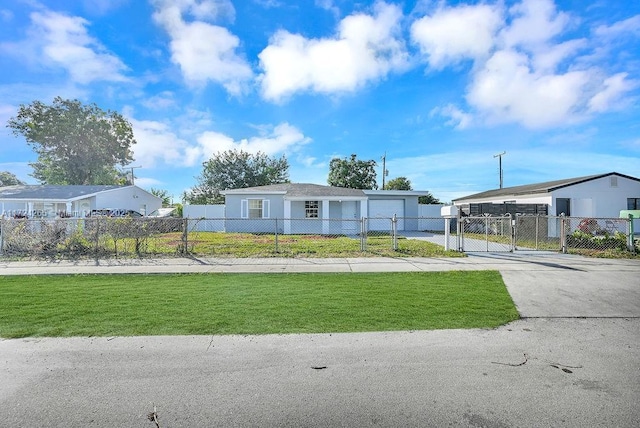 manufactured / mobile home with a front yard and a garage