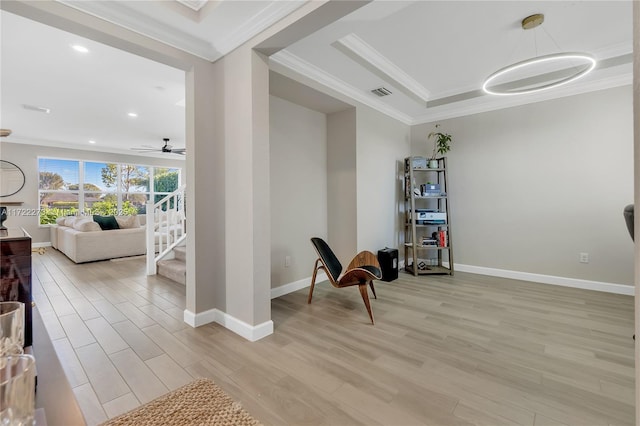 living area with light wood-type flooring, ceiling fan, and crown molding