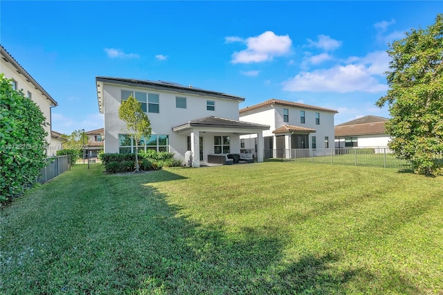 back of property with outdoor lounge area and a yard