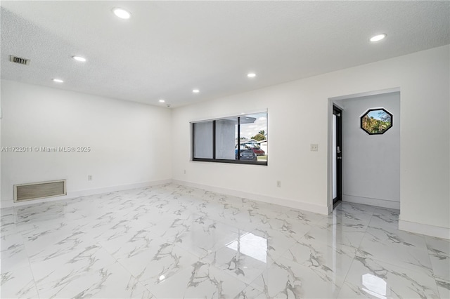 empty room featuring a textured ceiling