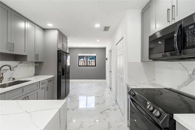 kitchen featuring electric range, gray cabinetry, and sink