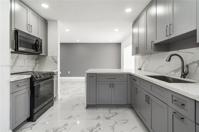 kitchen featuring gray cabinetry, light stone countertops, sink, black electric range, and kitchen peninsula