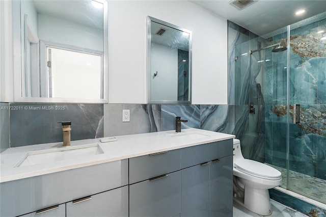 bathroom with vanity, decorative backsplash, toilet, tile walls, and an enclosed shower