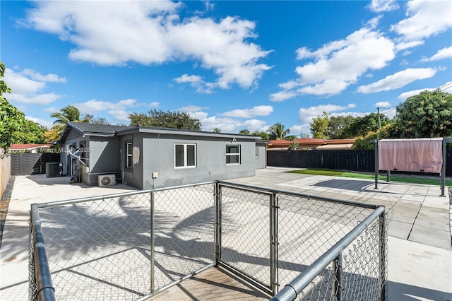 back of house with a patio area and central air condition unit