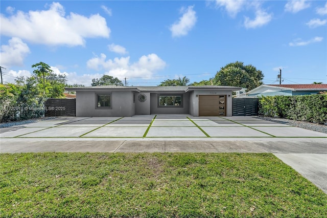 view of front of home with a front yard and a garage