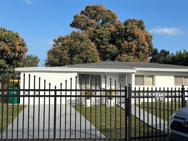 view of gate with a lawn