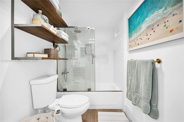 full bathroom with shower / bath combination with glass door, wood finished floors, and toilet