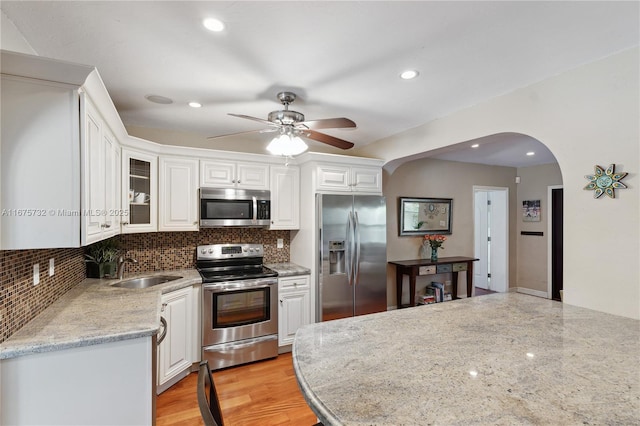 kitchen featuring white cabinetry, sink, and appliances with stainless steel finishes