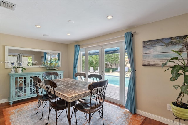 dining room with french doors and wood-type flooring