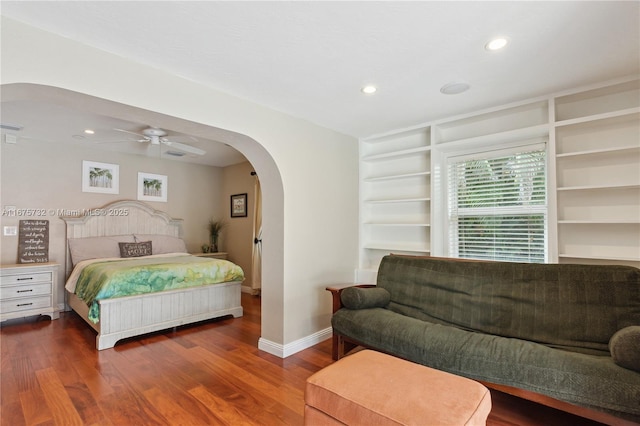 bedroom with ceiling fan and dark hardwood / wood-style flooring