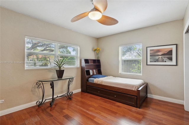 bedroom with ceiling fan and wood-type flooring