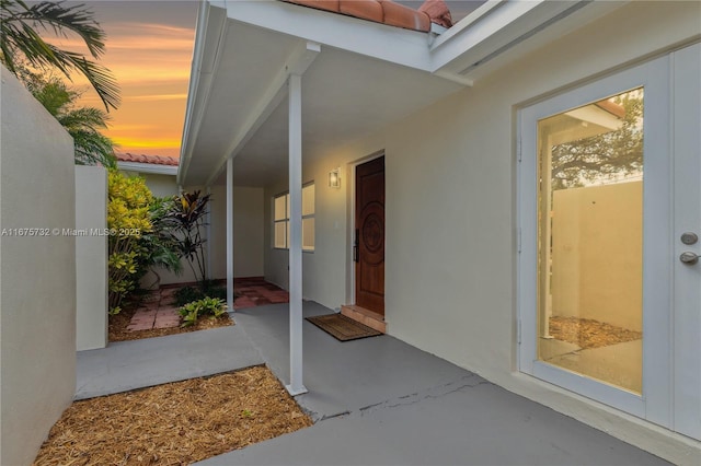 view of exterior entry at dusk