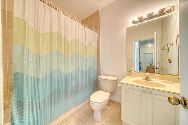 bathroom with tile patterned flooring, vanity, toilet, and walk in shower