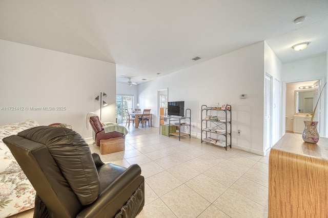 tiled living room featuring ceiling fan