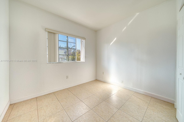 spare room with light tile patterned floors