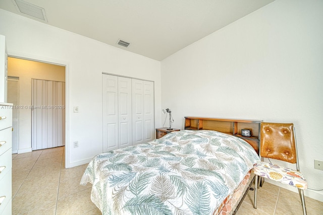 bedroom with a closet and light tile patterned flooring