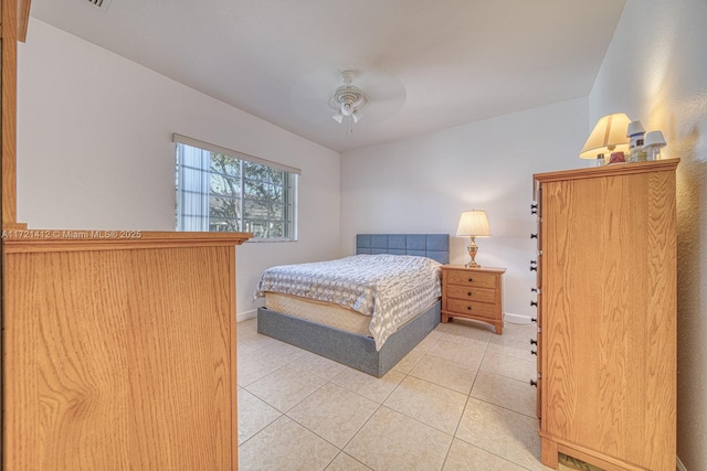 bedroom with ceiling fan and light tile patterned flooring