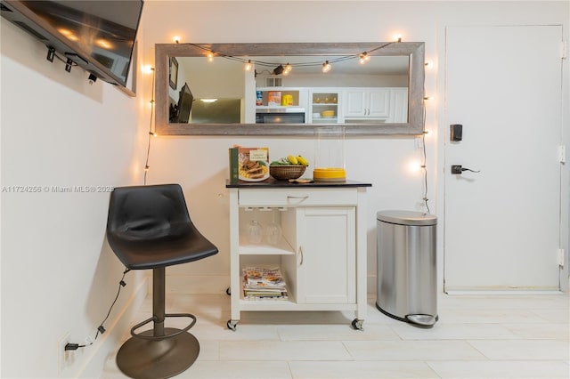 bar featuring white cabinets