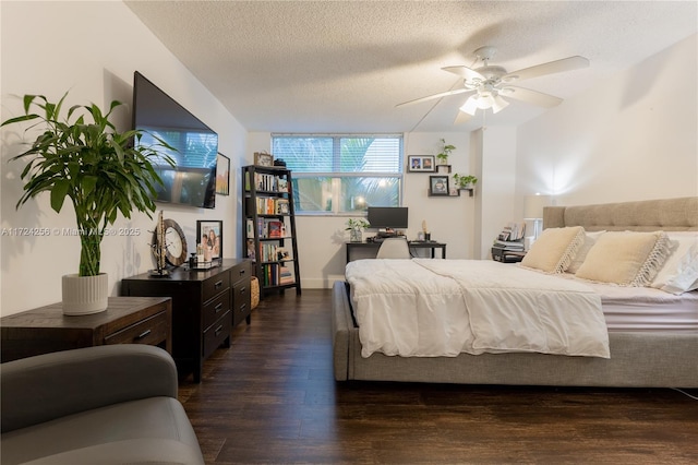 bedroom with dark hardwood / wood-style flooring, a textured ceiling, and ceiling fan