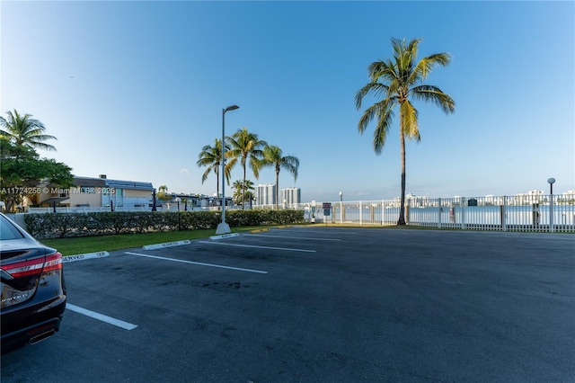 view of car parking with a water view