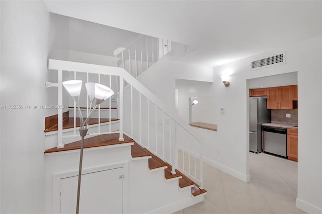 stairs with tile patterned flooring