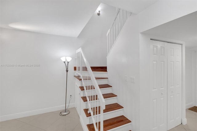 stairway with tile patterned floors