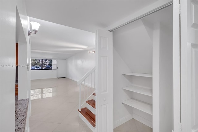 hall featuring light tile patterned floors