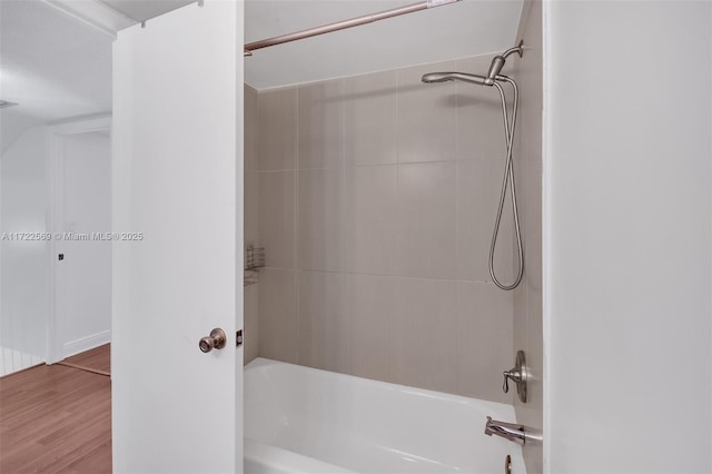 bathroom featuring tiled shower / bath combo and hardwood / wood-style flooring