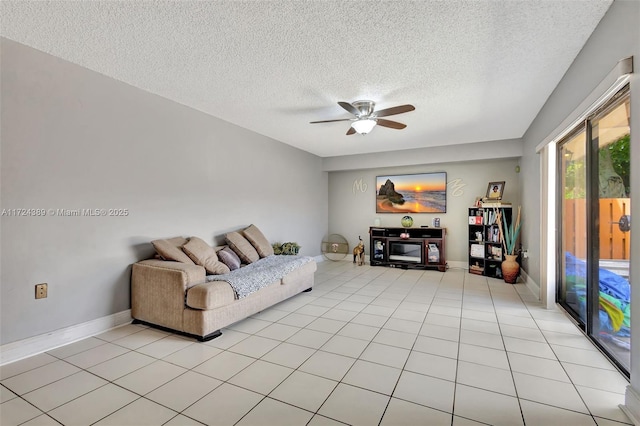 tiled living room featuring ceiling fan and a textured ceiling