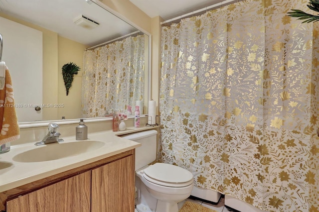 bathroom featuring tile patterned floors, vanity, and toilet