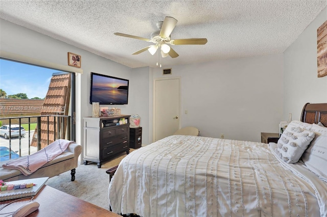 bedroom with ceiling fan and a textured ceiling